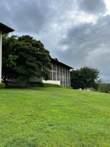 a building with a tree in the middle of a field at Monte Castelo Flat 08B in Sairé