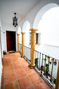 a hallway of a building with columns and a door at Castillo de Marbella in Marbella