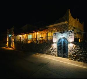a stone building with lights on it at night at Kokkala Guestrooms in Kokkala
