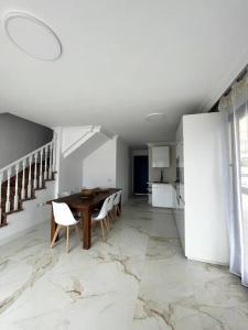 a dining room with a table and chairs and a kitchen at Sunset of Duke#Luxury Costa Adeje in Adeje