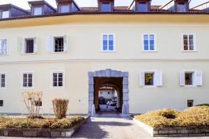 an entrance to a white building with an archway at Central Oasis-with parking in Ljubljana