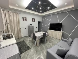 a living room with a couch and a table and a tv at Dream House in Catania