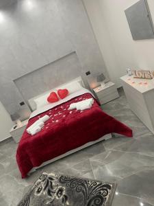 a bedroom with a red bed with two hearts on it at Dream House in Catania