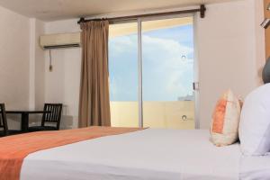 Postel nebo postele na pokoji v ubytování Hotel Calypso Cancun