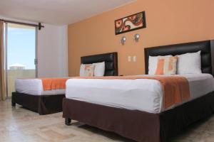 Postel nebo postele na pokoji v ubytování Hotel Calypso Cancun