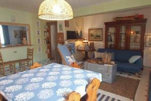 a living room with a blue bed and a blue couch at Centro Lampedusa via Roma in Lampedusa