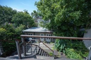 a stairway leading up to a house with a fence at Eggie's Nest - Luxury City Apartment in Sydney