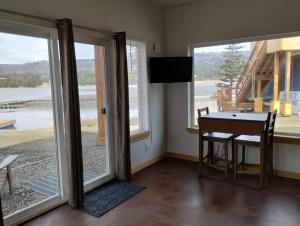a room with a table and sliding glass doors at Fireweed Cabin - Homer Seaplane Base in Homer