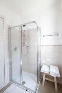 a glass shower stall in a bathroom with a bench at B&B Castello Cimbergo in Cimbergo +39 photos