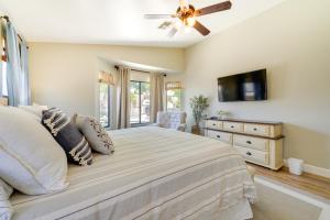 a bedroom with a bed and a ceiling fan at Near Hiking and Golfing Phoenix Home with Pool! in Phoenix +32 photos