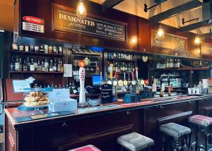 a bar with a lot of bottles of alcohol at Mortonhall in Edinburgh