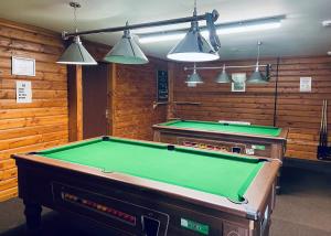 a room with a pool table and some lights at Mortonhall in Edinburgh