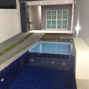 a swimming pool with blue tile in a house at Carapibus, Conde PB in Conde