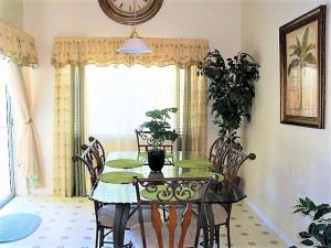 a dining room with a green table and chairs at 6 bedrooms pool home 10 min from Disney in Orlando