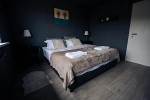 a bedroom with a bed with two towels on it at Golden Circle Luxury Cottages in Selfoss