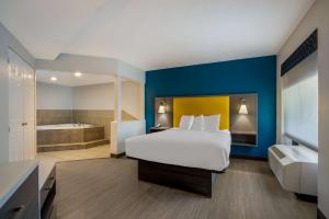 a hotel room with a bed and a bath tub at Best Western Bordentown Inn in Bordentown +21 photos