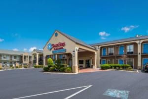 a front view of a hotel with a parking lot at SureStay Plus Hotel by Best Western Jackson in Jackson