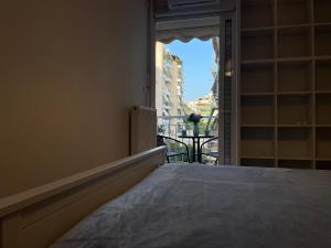 a bedroom with a bed and a view of a balcony at Traveller's Choice Attiki in Athens