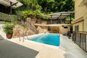 a swimming pool in front of a house at Hotel Stein Colonial in Cali