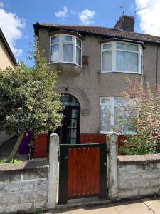 a house with a wooden door and a fence at 3 BEDROOM HOUSE IN A GREAT LOCATION in Childwall