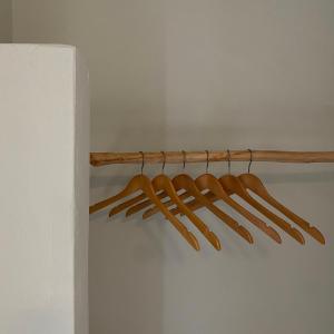 a bunch of wooden utensils hanging on a rack at Mellow Paros in Parikia