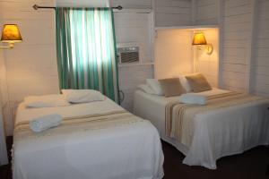 Postel nebo postele na pokoji v ubytování Hostal Corotu