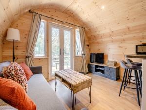 a living room with a couch and a tv at Farm View - Uk43708 in Cloughton