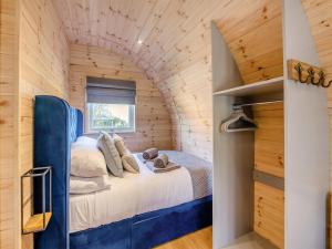 a bedroom with a bed in a wooden house at Farm View - Uk43708 in Cloughton