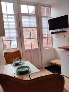 a kitchen with a table with a plate on it at appartement Rez-de-chaussée avec extérieur, a 150m du centre, 4min de la plage. in Mers-les-Bains