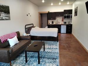 a living room with a bed and a couch at Grewingk Suite - Homer Seaplane Base in Homer +13 photos