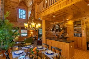 a dining room and kitchen in a log cabin at Cedarwood Lodge in Saugatuck