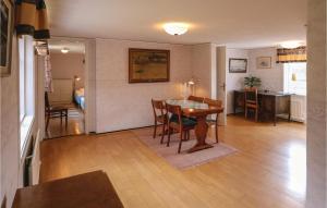 a dining room and living room with a table and chairs at Amazing Home In Hovmantorp With Wifi in Hovmantorp