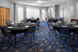 a conference room with long tables and chairs at Courtyard by Marriott San Diego Rancho Bernardo in Rancho Bernardo