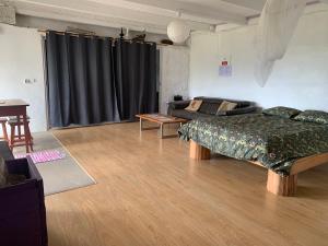 a living room with a bed and a couch at House with Forest View in Lajes das Flores