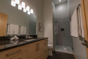 a bathroom with a sink and a shower at Malaya Dunes Walk To Laketown Beach in Holland