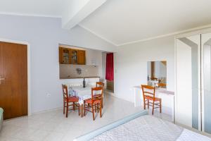 a kitchen and dining room with a table and chairs at Studio Brsec 7796a in Martina