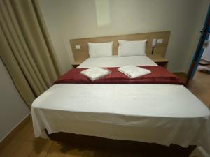 Un pat sau paturi într-o cameră la Hotel Novo México