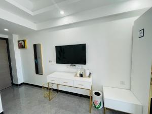 a white room with a tv on a white wall at Bohol Dolphin Bay Resort in Panglao
