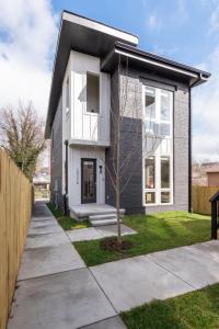 a white house with a fence and a sidewalk at Serene Boho Chic Home-Mins to DT in Nashville