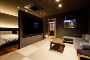 a living room with a couch and a bed at Hokuriku Yamashiro Onsen Hotel Kikyou in Yamashiro +64 photos