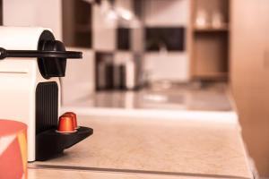 a close up of a coffee maker on a kitchen counter at Lilly's House in Volos