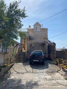 a car parked in front of a house at Apartments by the sea Zivogosce - Porat, Makarska - 21141 in Živogošće