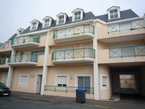 a building with balconies and a trash can in front of it at Appartement Les Sables-d'Olonne, 2 pièces, 4 personnes - FR-1-92-735 in Les Sables-d'Olonne