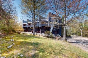 a large blue house with trees in front of it at Sunset Side in Campton