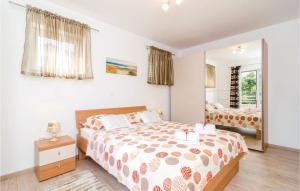 a bedroom with a bed and a mirror at Lovely Apartment In Cibaca With Kitchen in Mlini