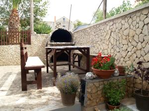 a patio with a table and a pizza oven at Apartments with a parking space Tkon, Pasman - 20400 in Tkon