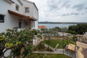 a house with a view of the water at Apartments and rooms by the sea Posedarje, Novigrad - 21123 in Posedarje