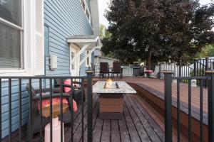 a wooden deck with a table on a house at The Manse in Whitefish