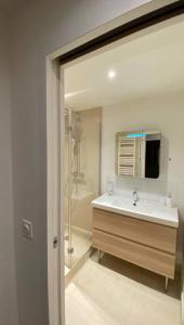 a bathroom with a sink and a shower at Astonishing Luxury Apartment in the South of Paris (NEW!) in Antony