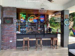 a bar with two stools in front of a building at Casa Paraiso del Lago in Prado